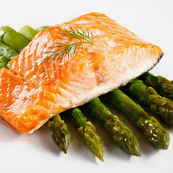 Steamed salmon parcels with fresh asparagus photo