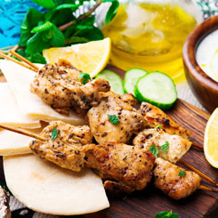 Grilled lemon & herb chicken skewers with steamed greens photo
