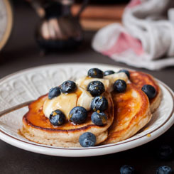 IsoWhey protein pancakes topped with berries and coconut yoghurt photo